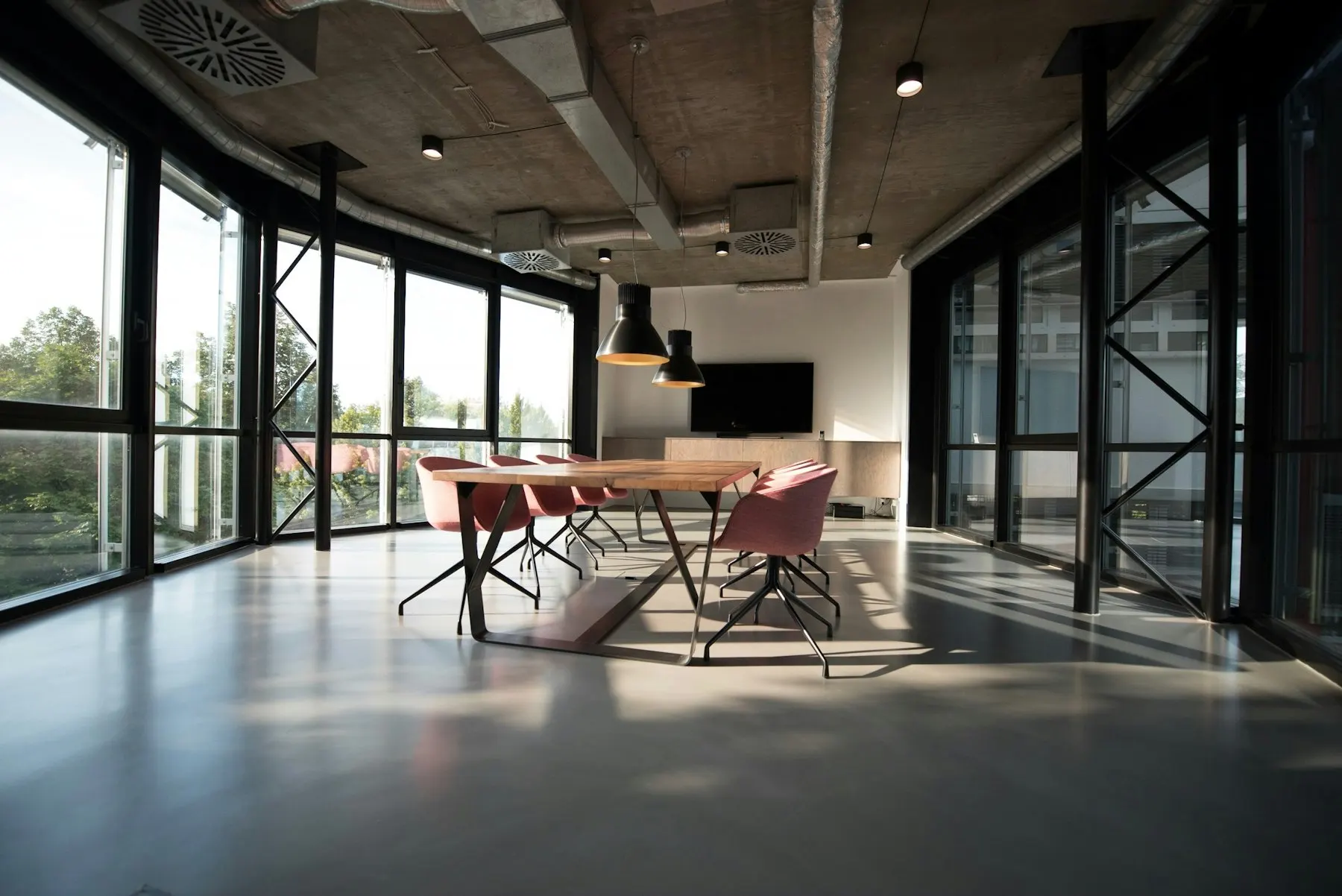 Modern glass-walled meeting room where the Azentra team plans projects